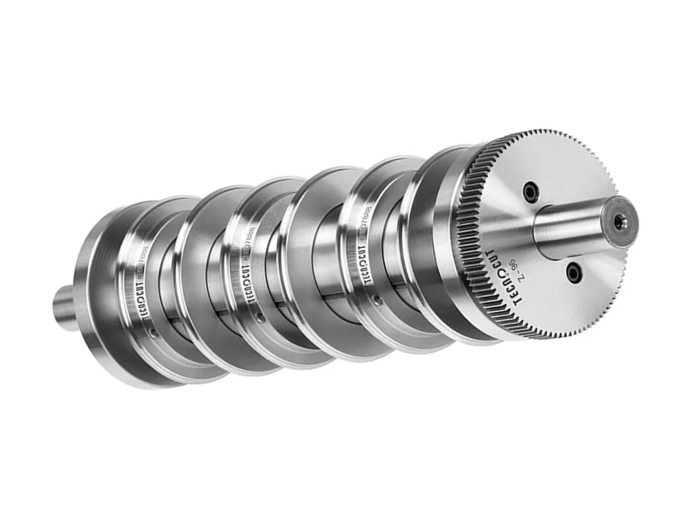 Tecnocut slitting shaft with the knife rings fitted and the gear at one end
