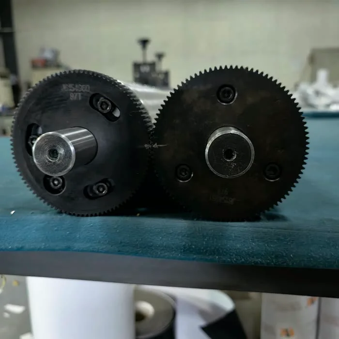 Gears of the embossing cylinders, which keep them synchronised
