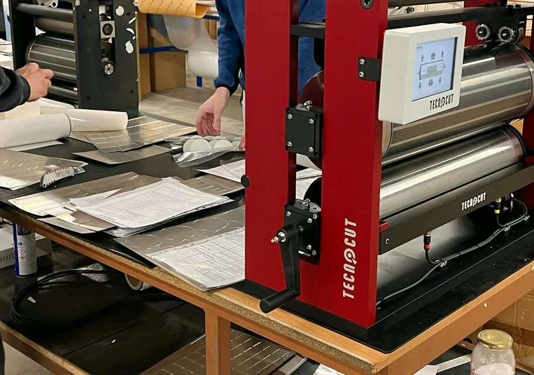 Freshly made flexible dies on the inspection table, next to the mounting machine